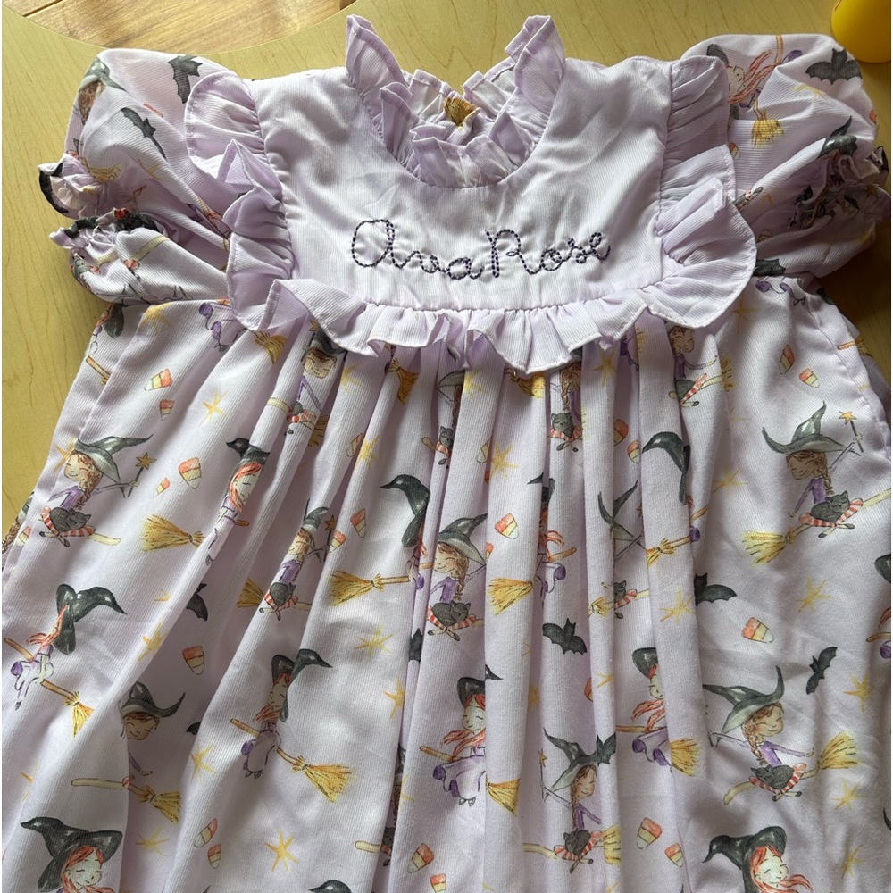 Smockingbird dress.Ava rose is stitched on the front but could be removed